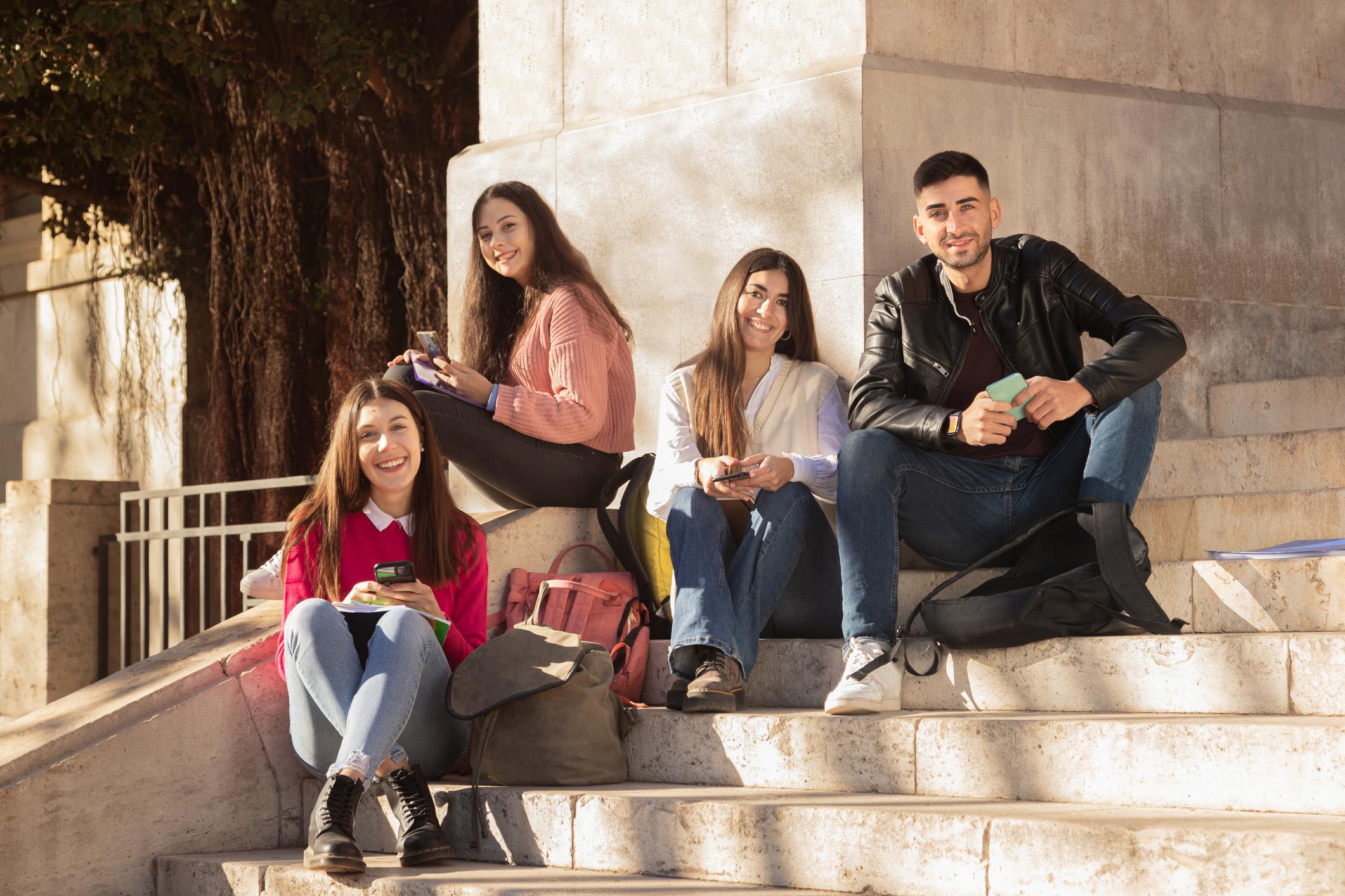 students sitting on stairs studying